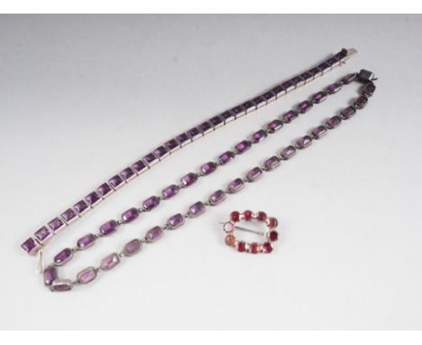A silver and amethyst tennis bracelet, a similar necklace, a silver and paste eternity ring, a silver and paste star brooch, 
