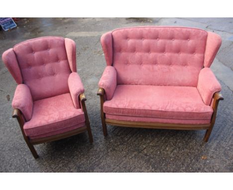 An Ercol carved oak showframe wingback two-seat settee and matching armchair, settee 49" wide 