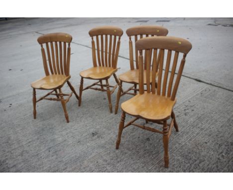A set of four Stuart Linford oak lath back kitchen chairs with panel seats, on turned and stretchered supportsCondition:Some 