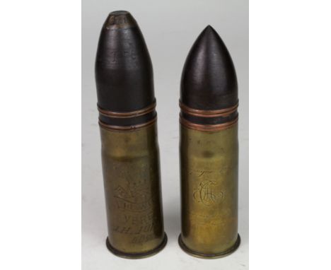 A pair of inert 1pdr canon shells, casing engraved 'Camtagne 1914-15", 'Souvenir Du Bois Franco-Allemand', Casing engraved 'T