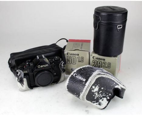 Canon A1 camera, with instructions, in worn case, together with three Cannon lenses, comprising 50/1.8; 28/2.8 &amp; Zoom Len