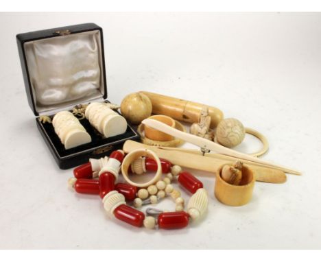 A collection of items, mostly ivory and bone, circa early 20th Century, including page turner, necklace, napkin ring, bangle,