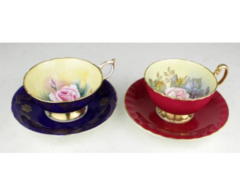 Pair of hand painted cup &amp; saucers, comprising Paragon &amp; Aynsley, second cup signed 'J. A. Bailey'
