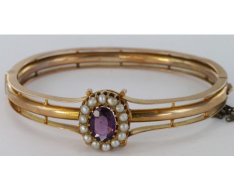 14ct gold hinged bangle set with an amethyst and pearl cluster, weight 16.3g