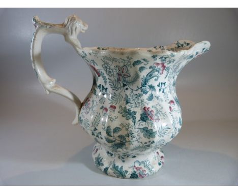 Staffordshire 'Chintz' decorated jug with lion finial to handle