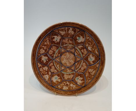 A Persian glazed ceramic lustre plate decorated with birds, fish and flowers. H.30cm