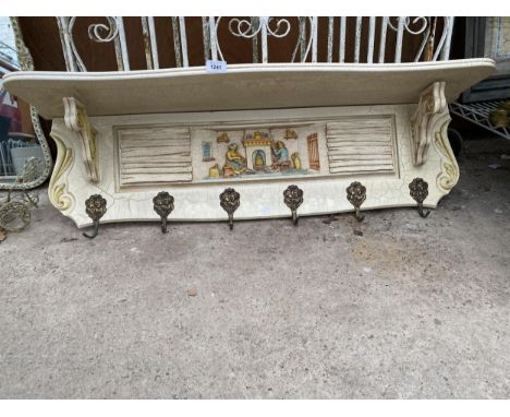 A VINTAGE COAT RACK WITH UPPER SHELF AND CARVED DESIGN 