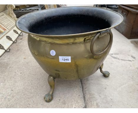 A LARGE VINTAGE BRASS COAL BUCKET ON LION PAW FEET 