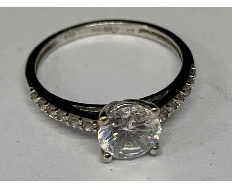 A 9 CARAT WHITE GOLD RING WITH SOLITAIRE CUBIC ZIRCONIA AND SMALLER ONES TO THE SHOULDERS SIZE I 