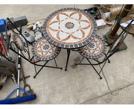 A TILE TOPPED WROUGHT IRON BISTRO SET COMPRISING OF A ROUND TABLE AND TWO CHAIRS 