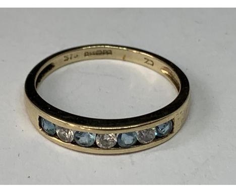 A 9 CARAT GOLD RING WITH FOUR AQUAMARINES AND THREE CUBIC ZIRCONIAS IN LINE SIZE M 