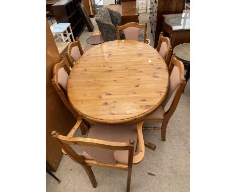 A TWIN PEDESTAL PINE DUCAL EXTENDING DINING TABLE AND SIX CHAIRS, TWO BEING CARVER 