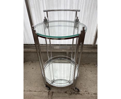 AN ART DECO STYLE CHROME TROLLEY WITH GLASS TOP AND MIRRORED BASE SHELF, 17" DIAMETER 