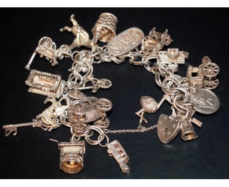 Silver Charm Bracelet Loaded With Approx 19 Charms To Include A Hinged Church, GJLtd St Christopher, Stork, 21 Key, Rocket En