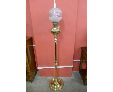 A brass oil lamp style standard lamp