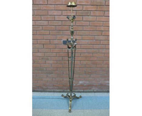 A brass tripod standard lamp