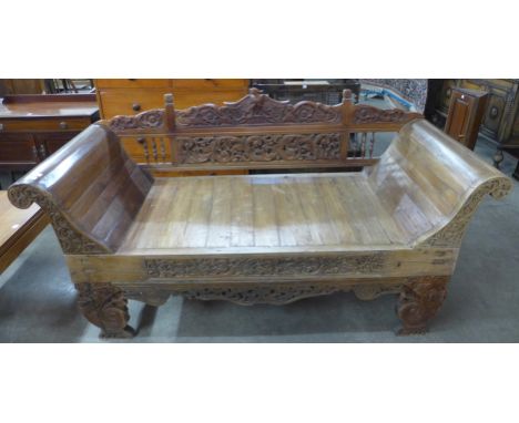 A Balinese hardwood bench sofa