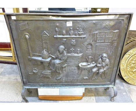 An early 20th Century embossed brass fire screen