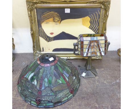 An Art Deco style print of a lady, candle lamp and a Tiffany style light shade