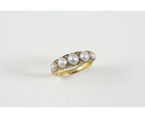 AN EARLY 20TH CENTURY PEARL AND DIAMOND RING the five graduated half pearls are set with rose-cut diamond highlights, in gold