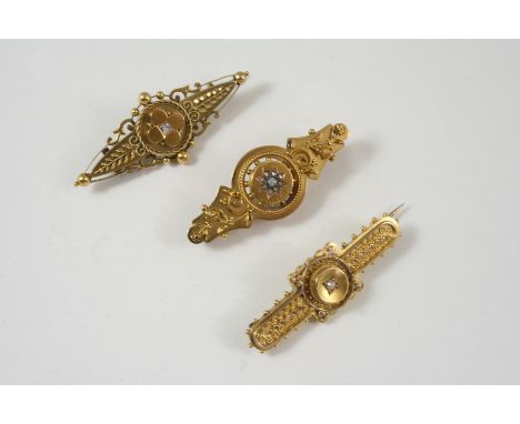 A VICTORIAN 15CT. GOLD AND DIAMOND BROOCH the gold mount with embossed foliate decoration and centred with a circular diamond