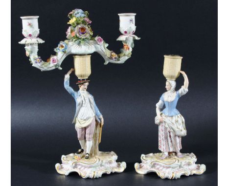 PAIR OF MEISSEN FIGURAL CANDELABRA, late 19th century, modelled as a country couple with baskets on their heads supporting tw