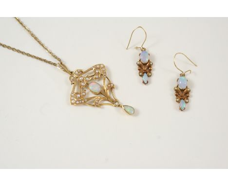 AN EDWARDIAN OPAL AND PEARL PENDANT the gold openwork foliate mount is centred with an oval solid white opal, overall with gr
