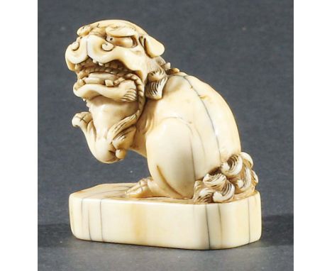 JAPANESE IVORY NETSUKE, probably 18th century, carved as a karashishi, height 3.5cm