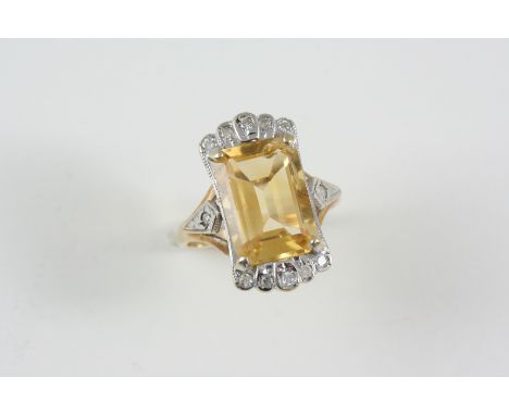 A CITRINE AND DIAMOND RING the rectangular-shaped citrine is set with circular-cut diamonds, in 9ct. gold. Size P.