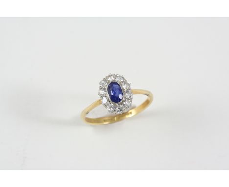 A SAPPHIRE AND DIAMOND CLUSTER RING the oval-shaped sapphire is set within a surround of ten old brilliant-cut diamonds, in 1