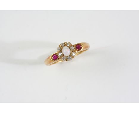 AN OPAL AND DIAMOND CLUSTER RING the oval cabochon opal is set within a surround of rose-cut diamonds, with two small rubies 