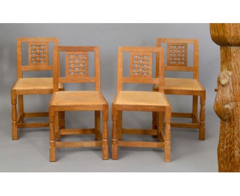 ROBERT THOMPSON OF KILBURN - 'MOUSEMAN' DINING CHAIRS a set of four oak dining chairs, with lattice back panels and leather s