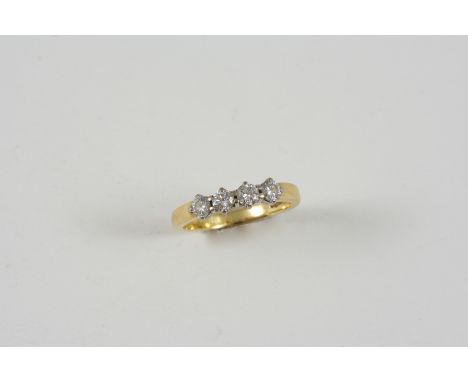 A DIAMOND FOUR STONE RING the four circular-cut diamonds are set in 18ct. gold. Size J.