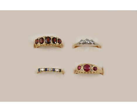 A DIAMOND THREE STONE RING the three circular-cut diamonds are set in gold, size P 1/2, together with a garnet and rose-cut d