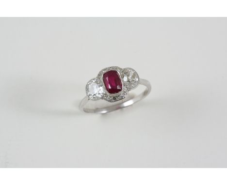 A RUBY AND DIAMOND CLUSTER RING the cuhion-shaped ruby is set within a surround of two old brilliant-cut diamonds and four si