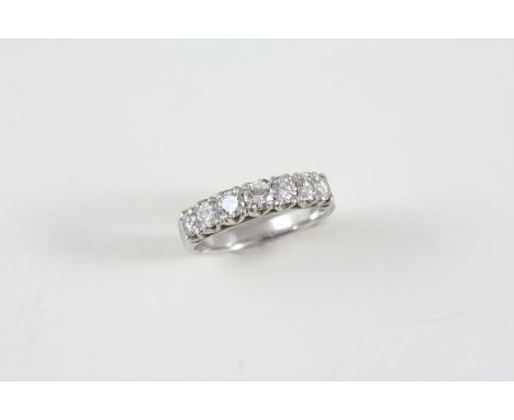 A DIAMOND HALF HOOP RING set with seven circular-cut diamonds. Size L.