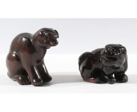TWO JAPANESE WOOD NETSUKE, carved as shishi and another creature (2)
