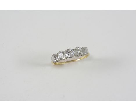 A DIAMOND FIVE STONE RING the five cushion-shaped diamonds are set in 18ct. gold. Size O.