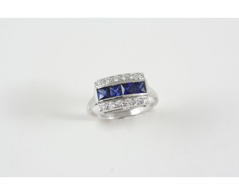 A SAPPHIRE AND DIAMOND RING the four square-shaped sapphires are set within a border of circular-cut diamonds, in 18ct. white