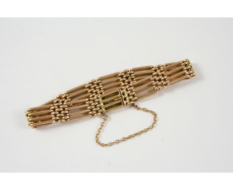 A 15CT. GOLD GATE LINK BRACELET with concealed clasp and safety chain, 18.5cm. long, 27 grams.