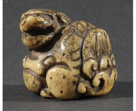 JAPANESE STAG ANTLER NETSUKE, carved as a shishi dog