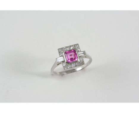 A PINK SAPPHIRE AND DIAMOND CLUSTER RING the octagonal-shaped pink sapphire is set within a surround of two baguette-cut and 