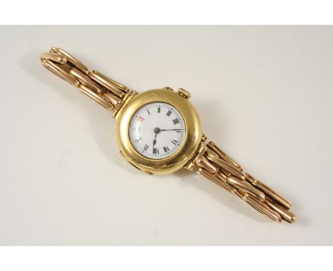 AN 18CT. GOLD WRISTWATCH the circular white enamel dial with black Roman numerals and one red Roman numeral at 12 o'clock, on