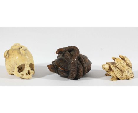 JAPANESE IVORY OKIMONO, later 19th century, carved as a human skull, a snake and snails, lacking lower jaw, length 4.5cm; tog