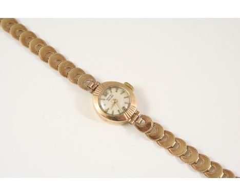 A LADY'S 9CT. GOLD WRISTWATCH BY VERTEX REVUE the signed circular dial with baton numerals and Arabic numerals at 12 and 6 o'