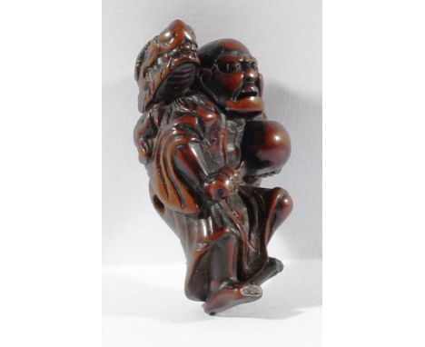 JAPANESE BOXWOOD NETSUKE, carved as gamma sennin with a dragon on his back, signature for Shuzan, height 5.5cm