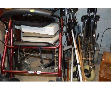 A FOLDABLE WHEEL CHAIR with basket and foot rests, two foldable walkers, mobile wheeled commode and walking sticks (12)