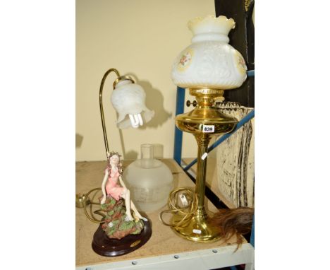 A CONVERTED BRASS OIL LAMP, twin burner, having brass reservoir and pressed milk glass shade with floral painted decoration, 