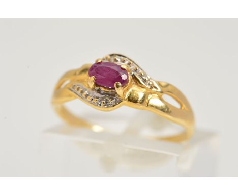 A RUBY AND DIAMOND RING, designed as an oval glass filled ruby in a four claw setting within an outer curved surround set wit