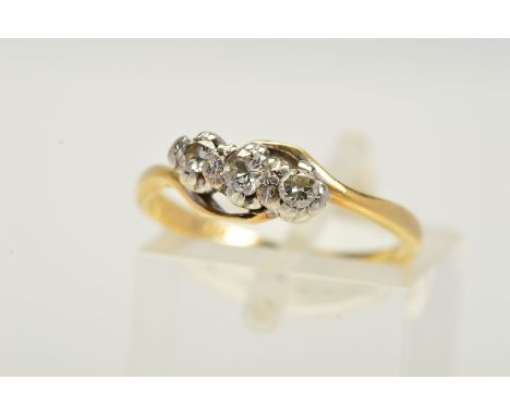 A THREE STONE DIAMOND RING, designed as a diagonal row of three graduated brilliant cut diamonds to the crossover design band